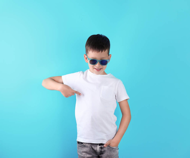 Little boy in t-shirt on color background. Mock-up for design - 写真・画像