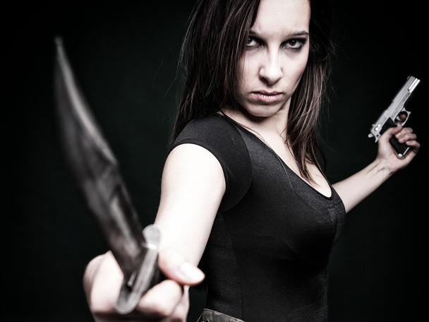 Sexy young woman long hair - gun knife - Photo, image