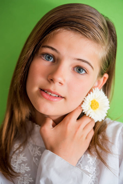 beautiful girl, cheerful emotional teenager, flower in hair, green summer background. Beauty and fashion photo session. - Φωτογραφία, εικόνα