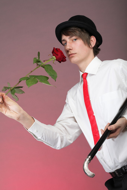 Portrait young man and rose enamoured love - 写真・画像