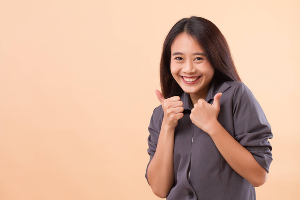 business thumb up; portrait of happy smiling asian business woman giving thumb up; happy smiling successful business woman giving accepting, approval, yes, good thumb up; asian young adult woman model - Valokuva, kuva