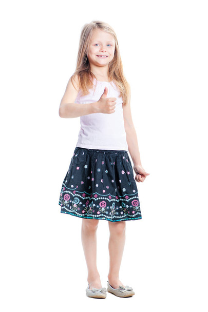 Cute little girl showing thumb up isolated on white. - Фото, зображення