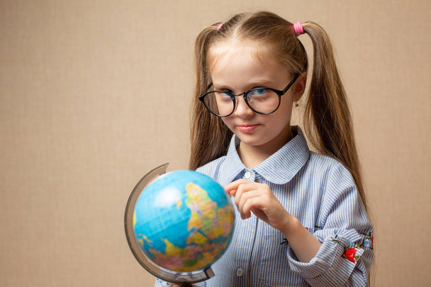 Little girl with globe. Education concept - Fotografie, Obrázek