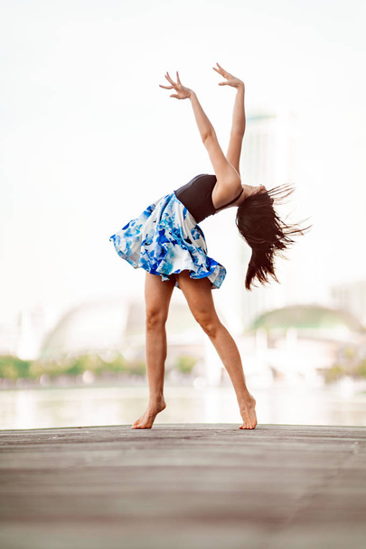 Beautiful Young Girl Dancing in the City, with background of skyscrapers  - Foto, Imagem