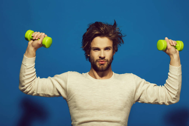 Morning workout. handsome man with barbell doing morning exercise, has uncombed hair - 写真・画像