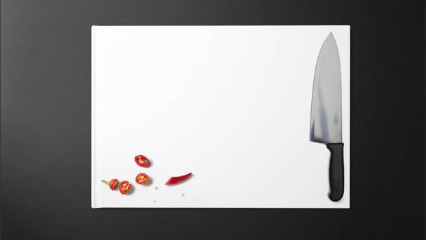 Posiekane chilli z ostry nóż na papierze białym na czarnym tle w kuchni - Zdjęcie, obraz