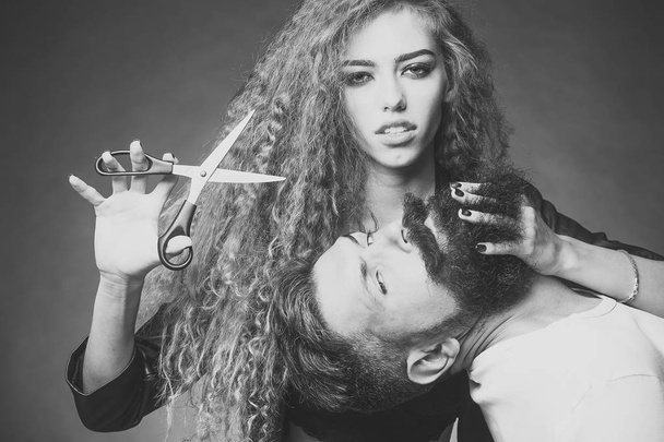 mens hair salon. Sensual couple posing with scissors - Photo, image