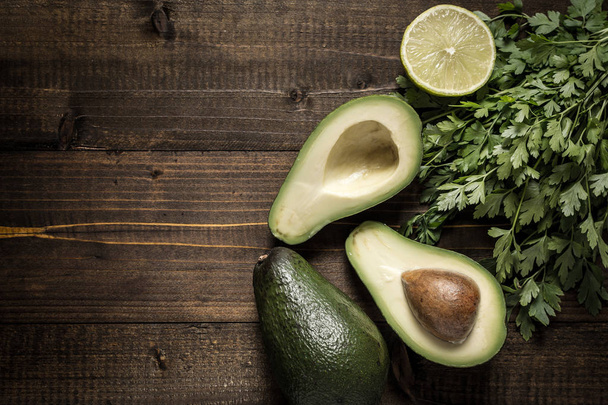 Avocado auf dunklem Holzgrund als gesundes Ernährungskonzept - Foto, Bild