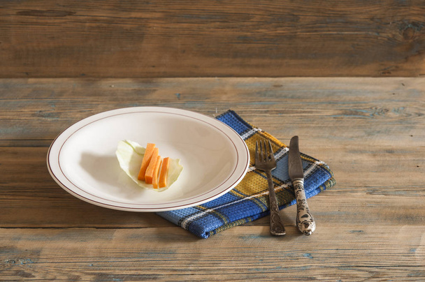 Diet plate of vegetables with carrot on wooden table - Foto, afbeelding