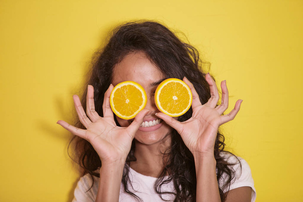 expressive asian woman with slices of fresh lemon - Foto, Imagen