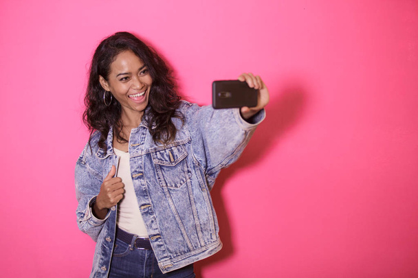 casual pretty woman taking selfies using mobile phone camera - Photo, Image