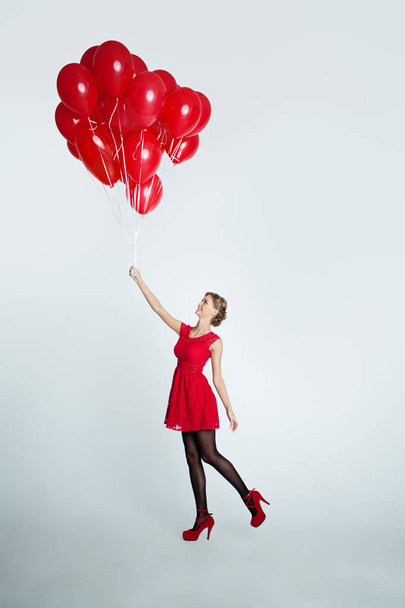 Cute Woman in Red Dress holding Balloons, Holiday Background - Foto, Imagem