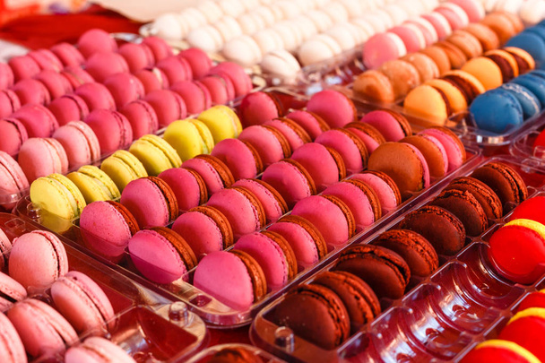 Many colorful delicious sweet macaroons in a box close-ups at a children's party - Photo, image