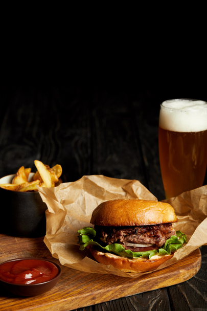 Hamburger and french fries served with cold beer in glass - Photo, Image