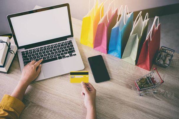 Joven mujer escribiendo portátil para el sitio web de compras en línea y la celebración de pago con tarjeta de crédito, Pago en línea y concepto de compras
. - Foto, imagen