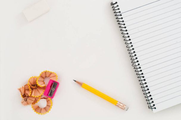 notebook with pencil, eraser and sharpener on  white background  - Zdjęcie, obraz