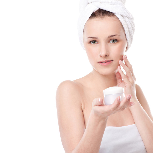 Woman applying moisturizer cream on face - Foto, Bild