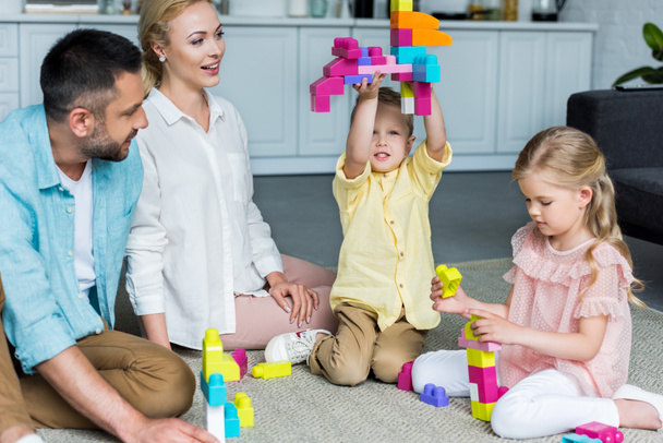 happy family playing with colorful blocks at home - Fotografie, Obrázek
