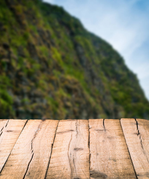 textured wooden planks on blurred hill background - Photo, Image