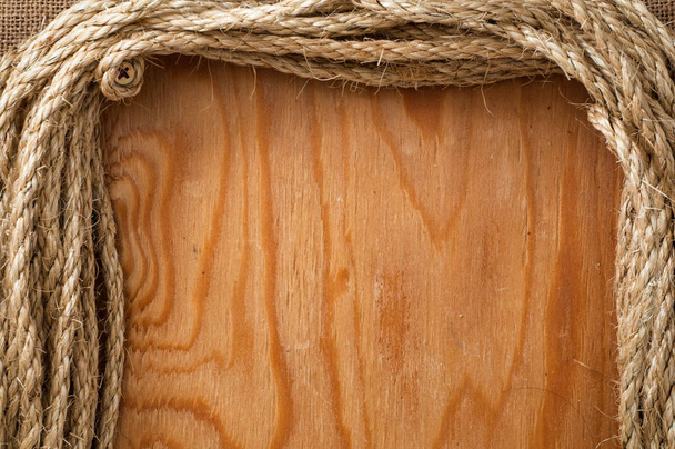marco de cuerdas con superficie de madera vacía como fondo
  - Foto, imagen
