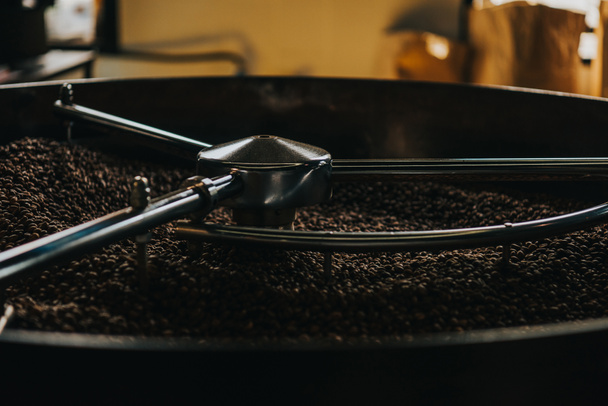 Roasting coffee beans in large coffee roaster - Fotó, kép