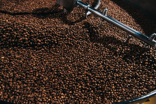 Roasting coffee beans in industrial coffee roaster - Foto, Bild