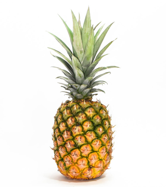 Fresh whole pineapple fruit standing isolated on white background - 写真・画像