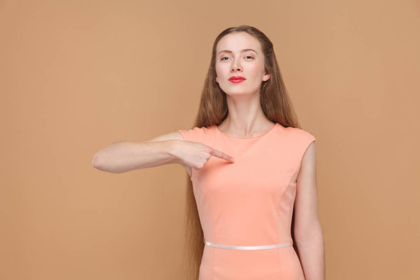 proud woman in pink dress pointing finger at herself , Expression emotion and feelings concept  - 写真・画像