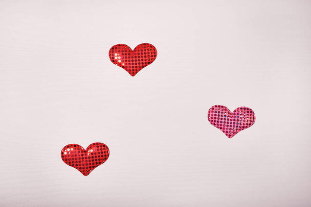Wooden white background with a branch of pine and three hearts. The concept for Valentine's Day - Photo, Image