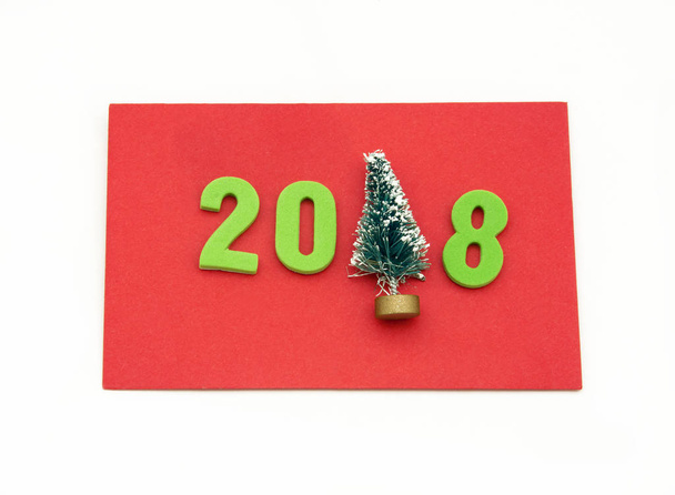 Red card congratulating christmas and year 2018, on white background - Valokuva, kuva