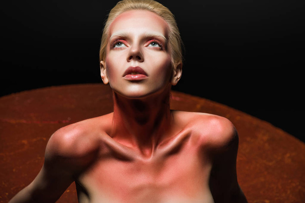 beautiful naked model with makeup posing for fashion shoot on black - Fotó, kép