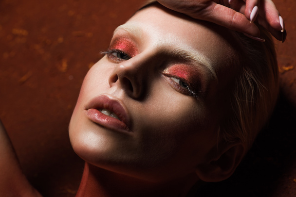 sensual girl with fashionable red makeup looking at camera - Foto, afbeelding