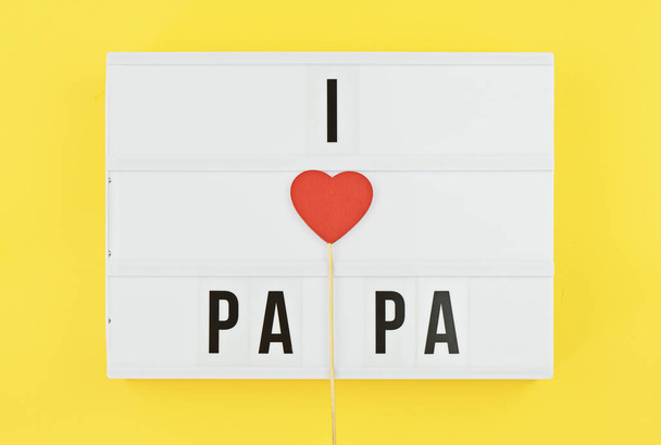 I love papa text on white lightbox with wooden heart on yellow background - 写真・画像