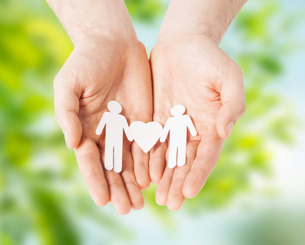 male hands holding paper gay couple pictogram - Фото, изображение