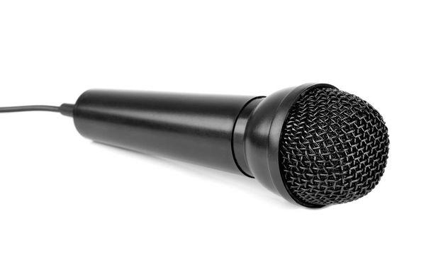 Un primer plano de un micrófono negro acostado sobre un fondo blanco
 - Foto, Imagen