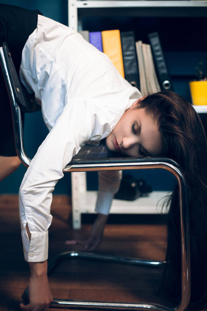 Lady sleeping on chair in weird pose. - Photo, image