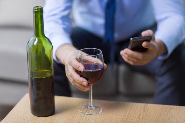 close up of man with alcohol and smartphone - Photo, Image