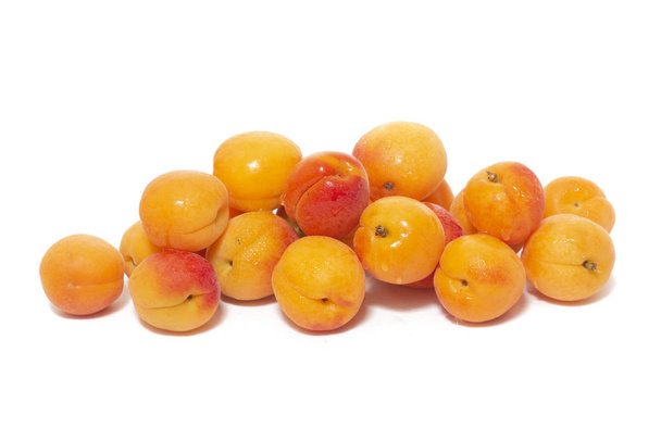 View of tasty Armenian plums (Prunus armeniaca) over a white wooden background. - Photo, Image