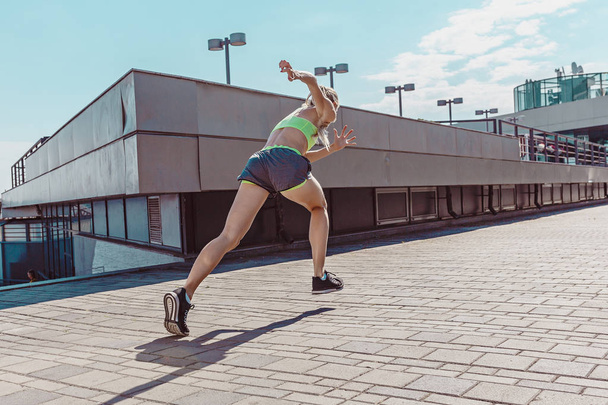 Pretty sporty woman jogging at city - Fotografie, Obrázek