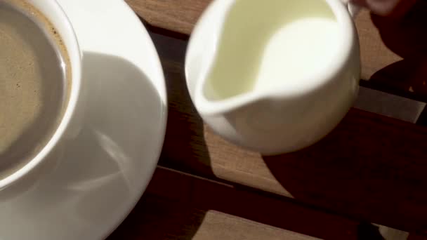 La taza en el platillo sobre la mesa de madera por la mañana
 - Metraje, vídeo