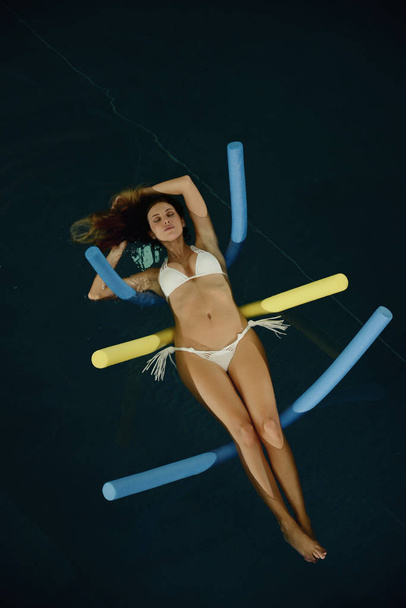 beautiful woman floating in the water in spa pool - Фото, зображення