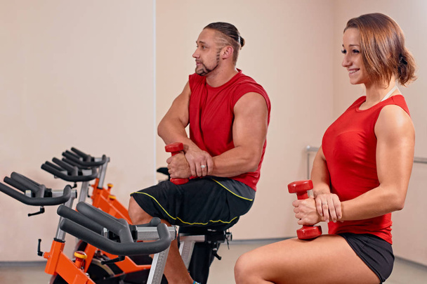 couple bycicle cycling in gym - Photo, Image