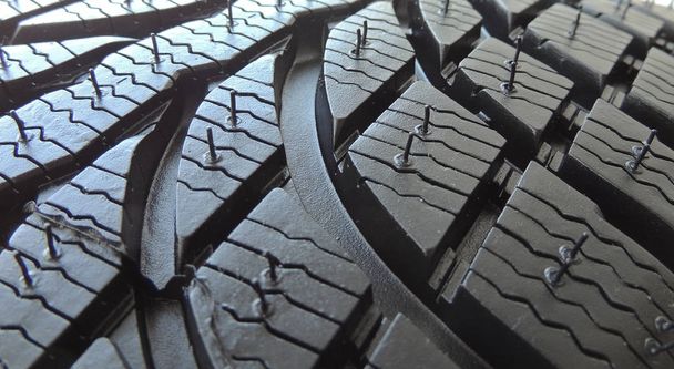 Rubber surface of new car tire with sipes and grooves close up  - Photo, Image