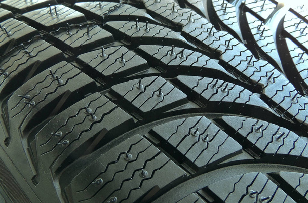 Tread area of new modern car tire with blocks and ribs close up - Photo, Image