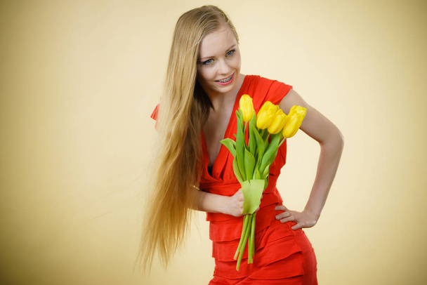 International women day, eight march. Beautiful portrait of pretty woman blonde hair with yellow tulips, fashion make up, elegant dress. Mothers day. - Foto, afbeelding