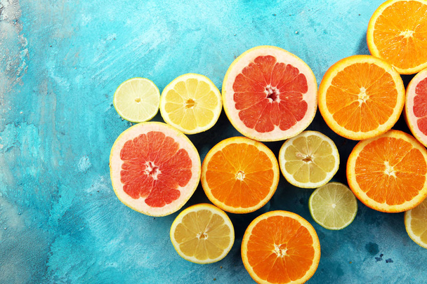 Citrus fruits with orange, lemon, grapefruit and lime on blue background - Photo, Image