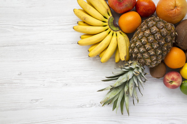 Fresh fruit on a white wooden background, from above. Copy space. Flat lay. - 写真・画像