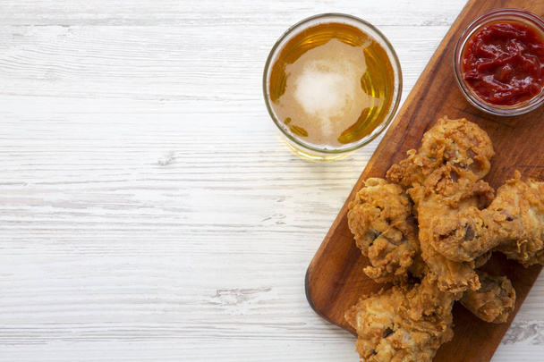 Fried chicken legs with sauce and cold beer, top view. Copy space. - Fotoğraf, Görsel