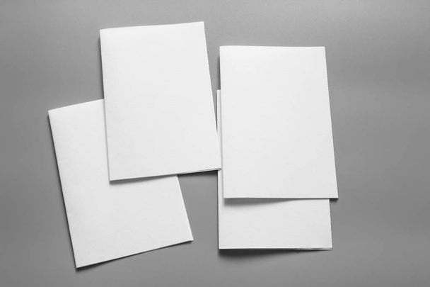 Blank portrait mock-up paper. brochure magazine isolated on gray, changeable background / white paper isolated on gray - Valokuva, kuva