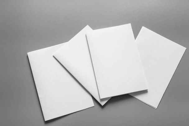 Blank portrait mock-up paper. brochure magazine isolated on gray, changeable background / white paper isolated on gray - Foto, Imagen
